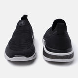 Black comfort sneakers by bugatti with a knit texture and a white sole.
