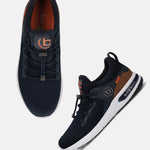 Dark blue athleisure sneakers by bugatti, with elastic lace-up closure and brown accents.