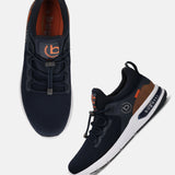 Dark blue athleisure sneakers by bugatti, with elastic lace-up closure and brown accents.