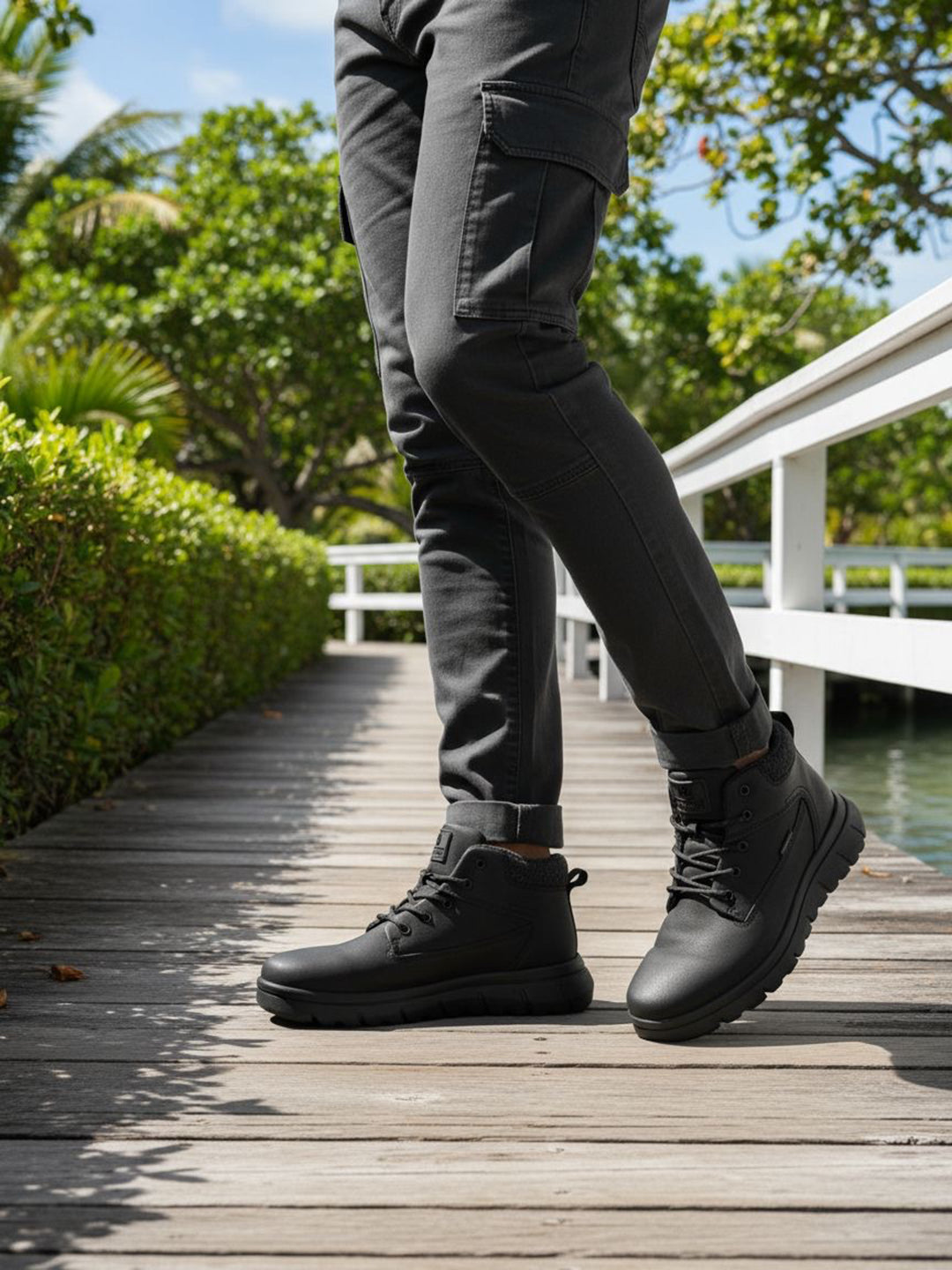 Black casual boots by Bugatti with a lace-up closure worn with gray cargo pants outdoors.