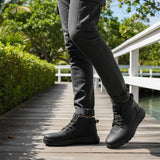 Black casual boots by Bugatti with a lace-up closure worn with gray cargo pants outdoors.