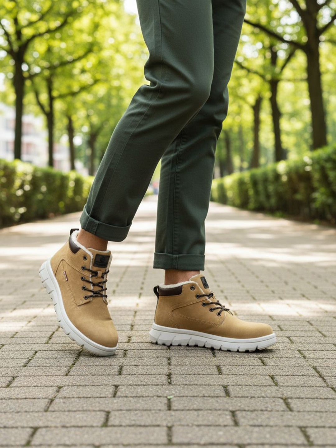 Tan casual comfort boots by Bugatti, with a white treaded sole and olive green rolled-up trousers.
