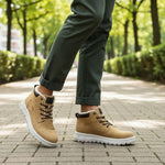 Tan casual comfort boots by Bugatti, with a white treaded sole and olive green rolled-up trousers.
