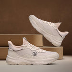 Beige bugatti Adelson Comfort Sneakers with breathable mesh and synthetic suede, presented on wooden display blocks.
