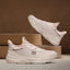 Beige bugatti Adelson Comfort Sneakers with breathable mesh and synthetic suede, presented on wooden display blocks.
