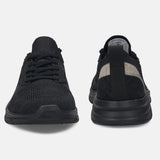 Black comfort mid-top sneakers by bugatti, with textured knit uppers and tonal soles.