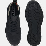 Black comfort mid-top sneakers by bugatti, with a knit texture and black soles.