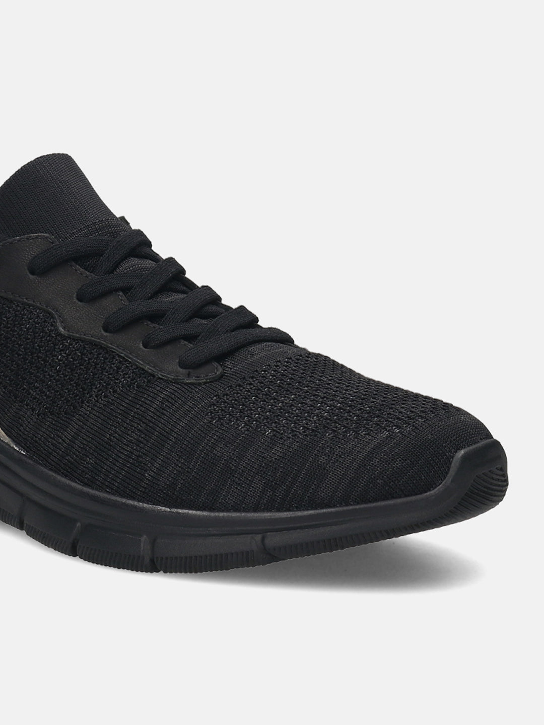 Black comfort sneakers by bugatti with knit textile and lace-up closure.
