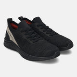 Black comfort sneakers by bugatti featuring a knit textile upper and tonal sole.