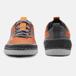 Orange comfort low-top sneakers by bugatti, featuring gray laces and a dark gray trim with white stitching.
