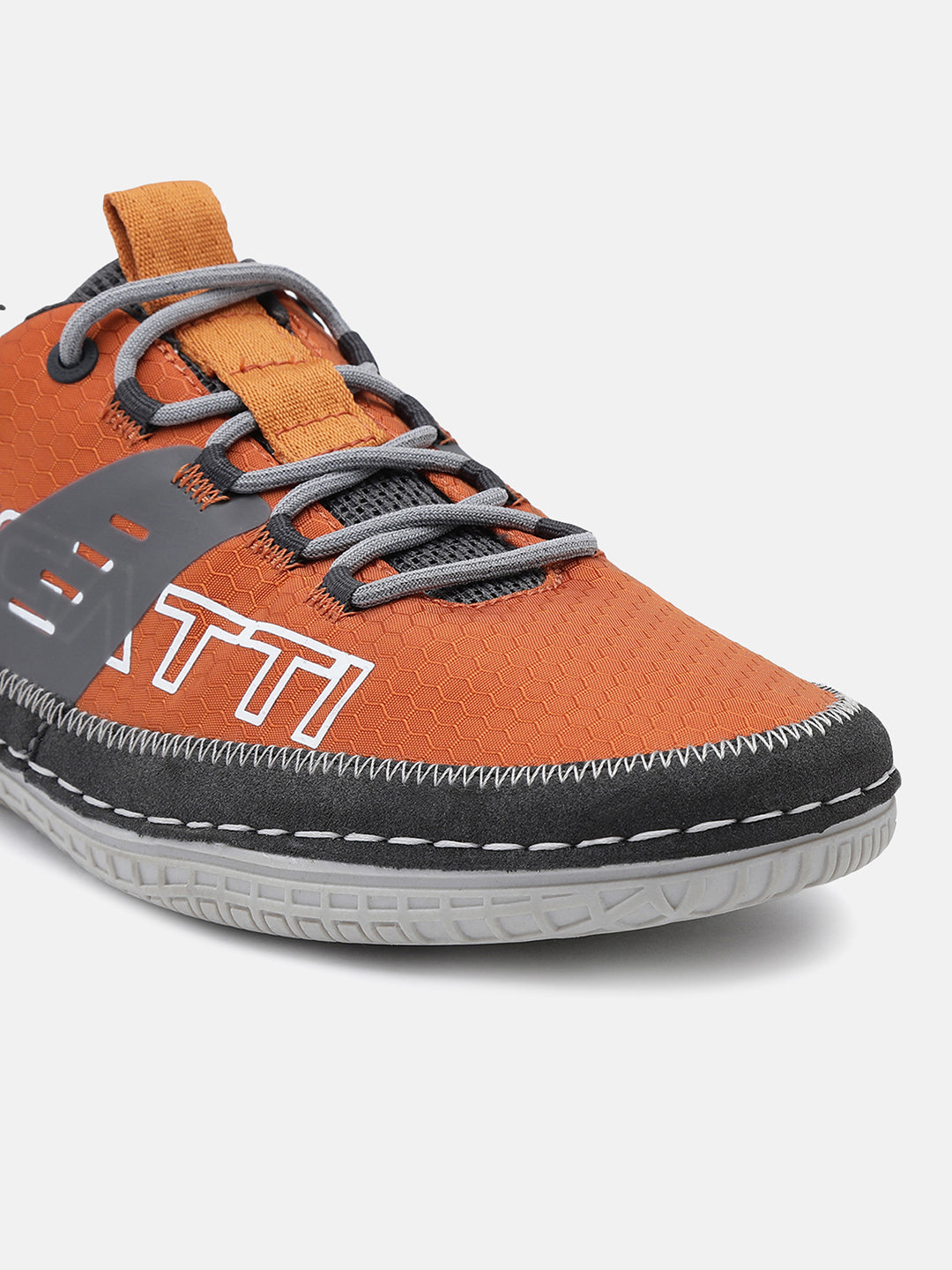 Orange low-top sneaker by bugatti with gray laces, a textured upper, and dark trim.
