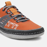 Orange low-top sneaker by bugatti with gray laces, a textured upper, and dark trim.