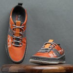 Orange comfort low-top sneakers by bugatti with gray accents and textured patterned details.