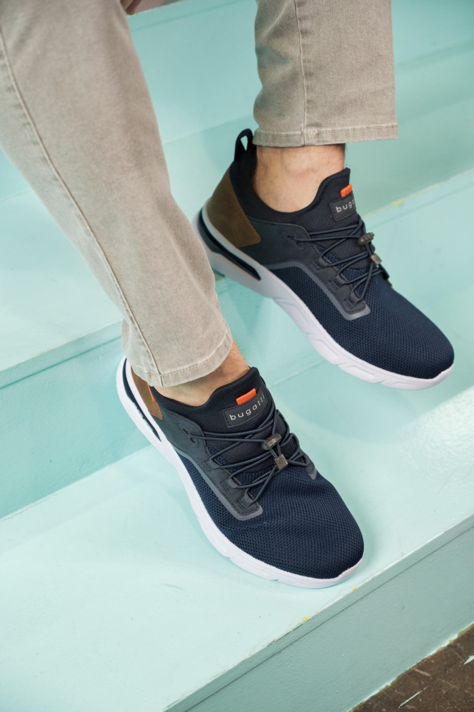 A blue Men's bugatti Athileisure Sneakers featuring a round plain toe, zero heels heel. Made from textile with a durable eva outsole, this laces design offers both style and comfort.