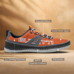 Orange textile low-top sneaker by Bugatti with grey laces and black trim, shown in a side view.
