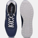 Dark blue comfort sneakers by bugatti, showing the white laces and white ridged soles.