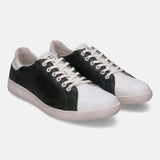White and dark green leather sneakers by bugatti with white laces and textured sole.