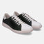 White and dark green leather sneakers by bugatti with white laces and textured sole.